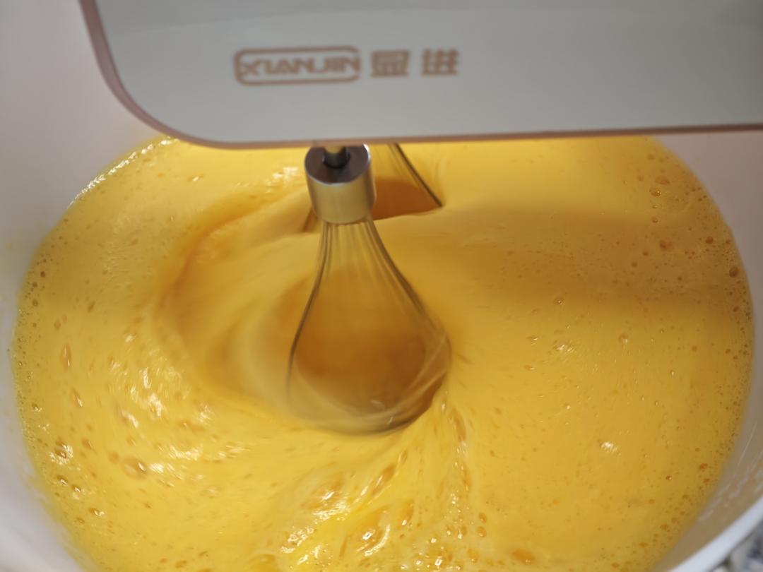 Whip the egg mixture on high speed until it turns ivory and grows dramatically in volume.