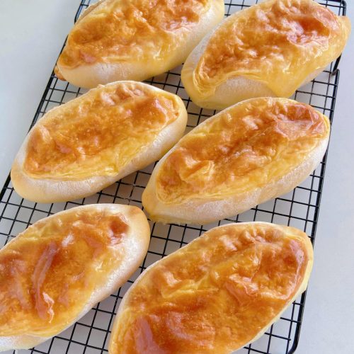 Rock-baked cheese bread (yan shao ru lao mian bao) - soft milk bread buns topped with a glossy, golden cheese crust