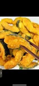 Deep fry the starch-coated pumpkin pieces until golden brown and crisp