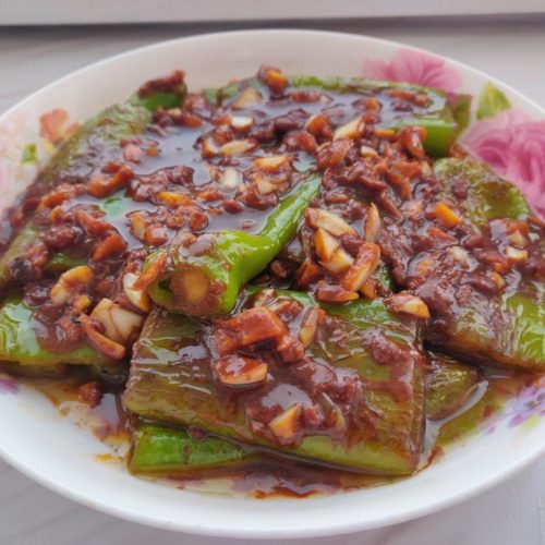 Blistered green peppers simmered in a dark soybean paste sauce