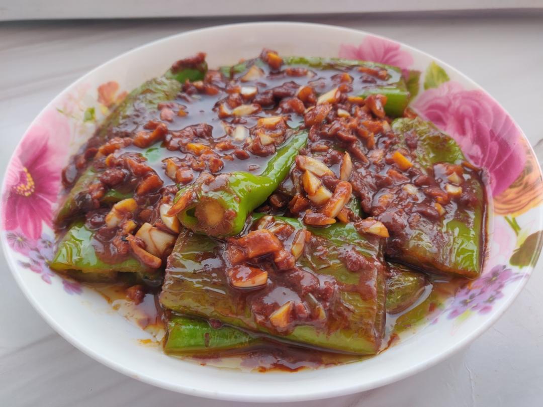 Blistered green peppers simmered in a dark soybean paste sauce