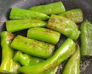 Pan-fry the peppers until the skins blister and char