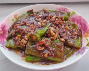 Toss the blistered peppers through the bubbling sauce until coated