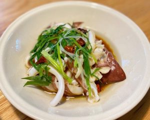Slice the squid, dress with steamed-fish soy, and top with scallion shreds