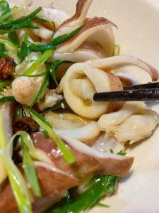 Pour the sizzling hot oil over the scallion shreds to bloom them