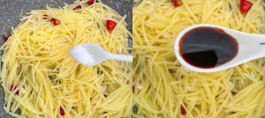 Sprinkle in the salt and chicken bouillon powder, then pour in the light soy sauce. Toss quickly to distribute the seasoning before the soy sauce scorches.