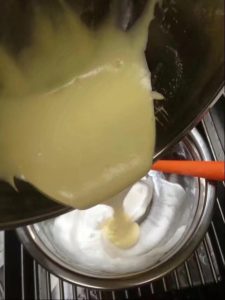 Fold a third of the meringue into the yolk base from the bottom up