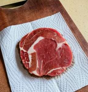 Pat the thawed steak completely dry with paper towels
