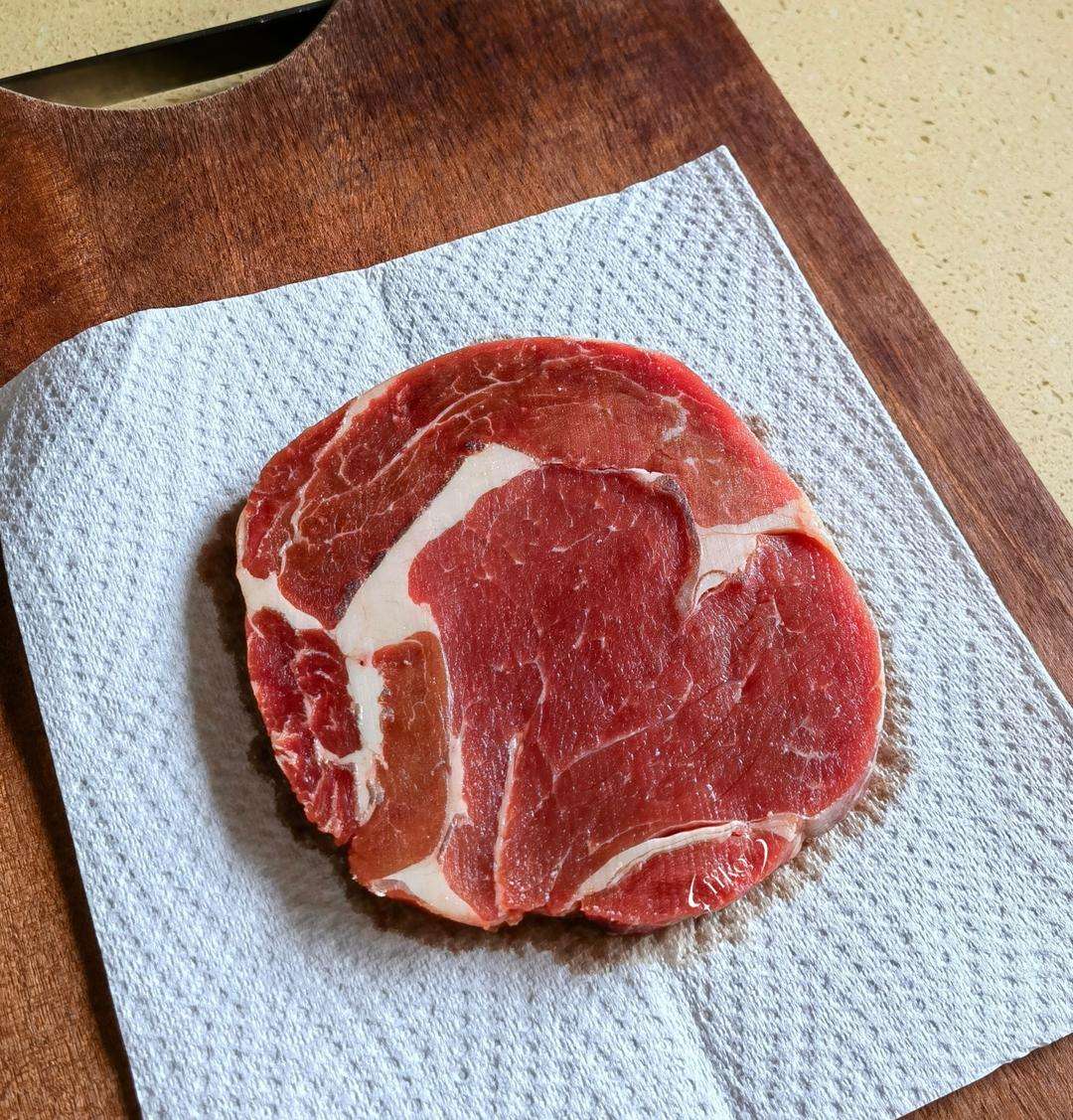 Pat the thawed steak completely dry with paper towels