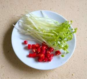 Wash the pea shoots and slice the bird's eye chilies into rings