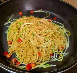 Toss the pasta with pea shoots, chilies, and sliced steak strips until just combined