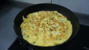 Splash in the wine, dust with white pepper, and serve the finished omelet