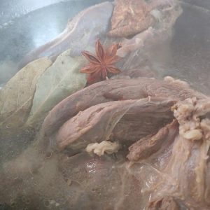 Refresh the pot with clean water, add the clove, bay leaves, and tangerine peel
