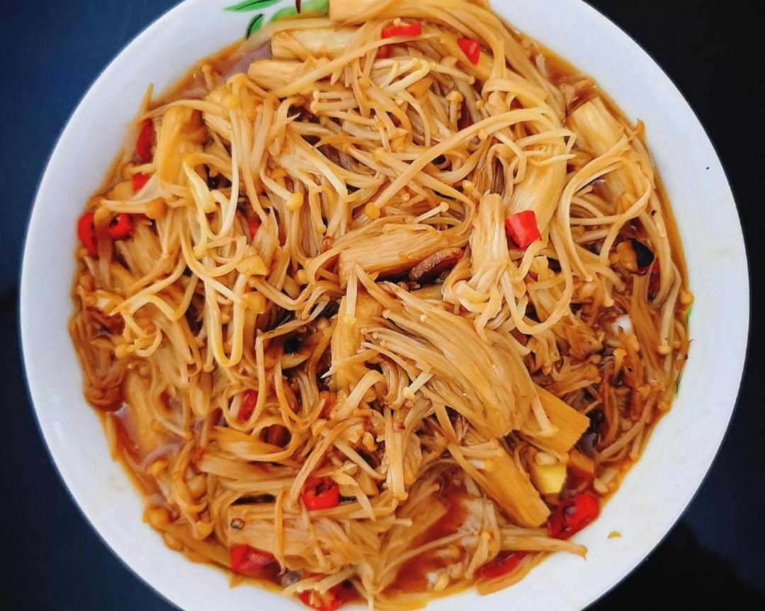 Spicy stir-fried enoki mushrooms glazed with soy and chili