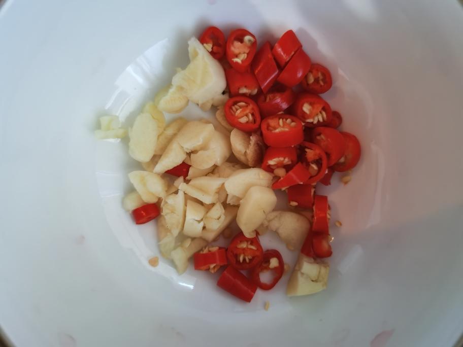 Mince the garlic and slice the bird's eye chilies