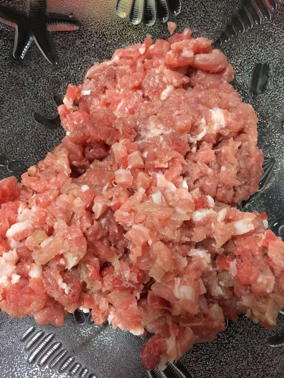 Cut the pork shoulder into small even cubes for the spicy pork sauce