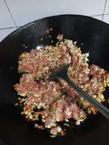Stir-fry the pork cubes until their moisture evaporates and the meat tightens