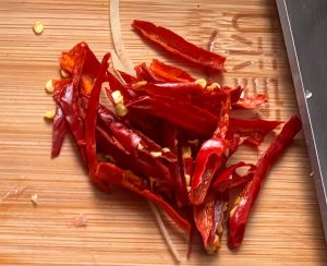 Slice the scallions and garlic and cut the dried chilies into threads