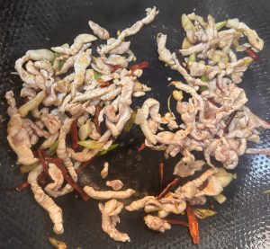 Stir-fry the pork with scallion and garlic, then season with the soy and oyster sauce