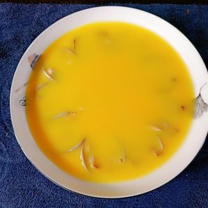 Stir the warm clam water into the beaten eggs
