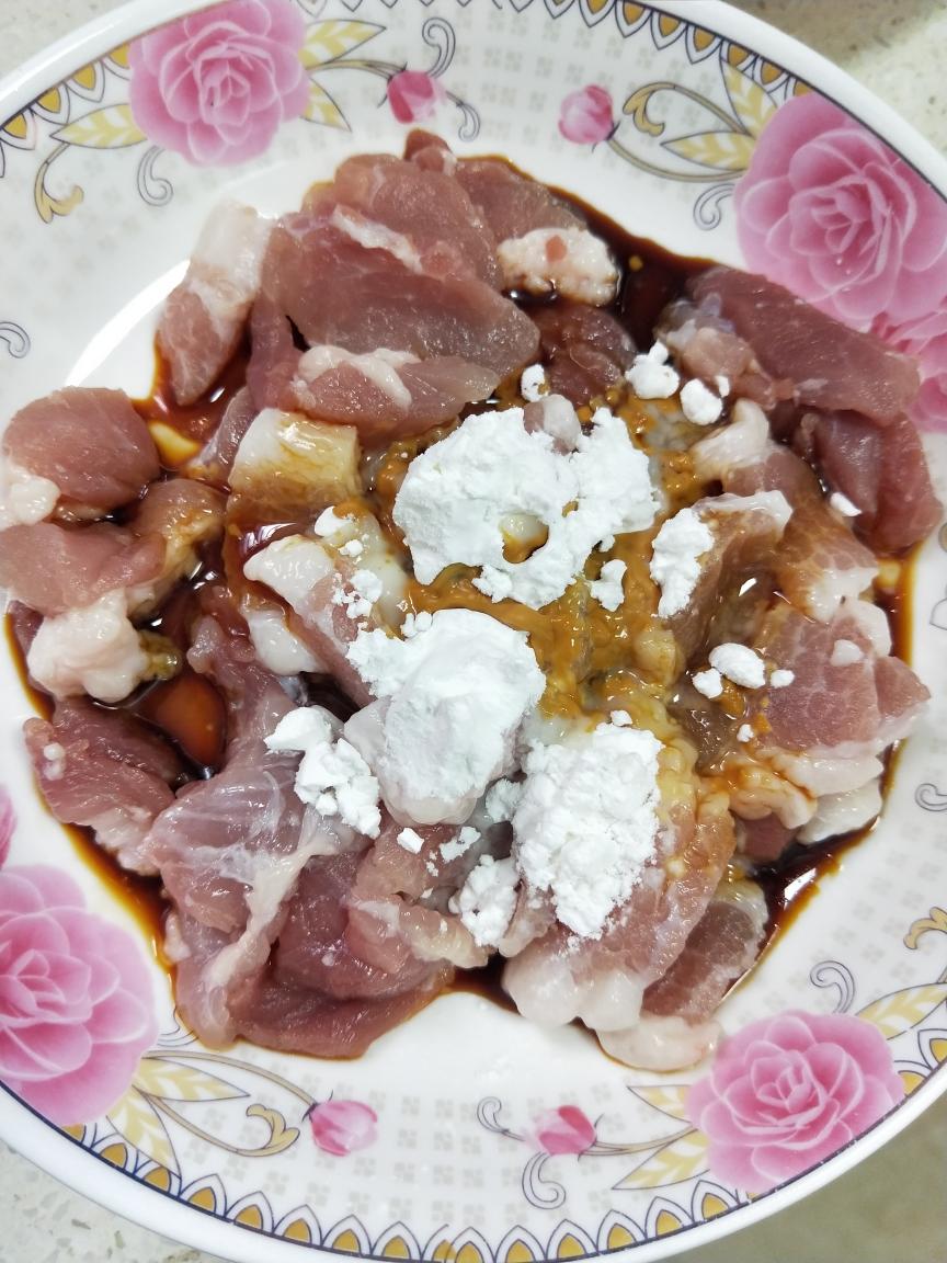 Marinate the thin pork slices with oil, soy, and cornstarch