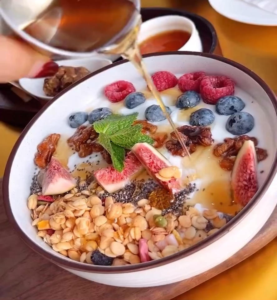 Spooning yogurt into a bowl as the base