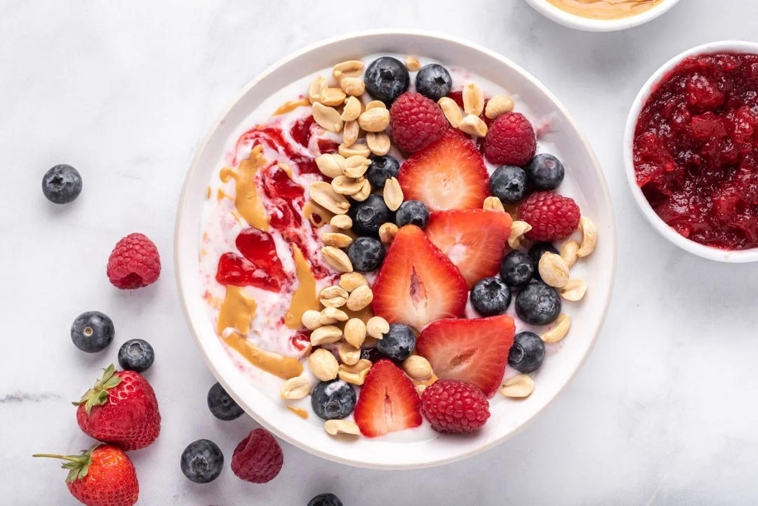 Layering fruits and toppings on the yogurt bowl