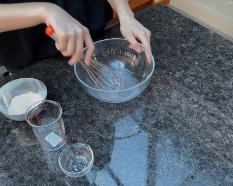 Mixing the poolish starter with water and yeast
