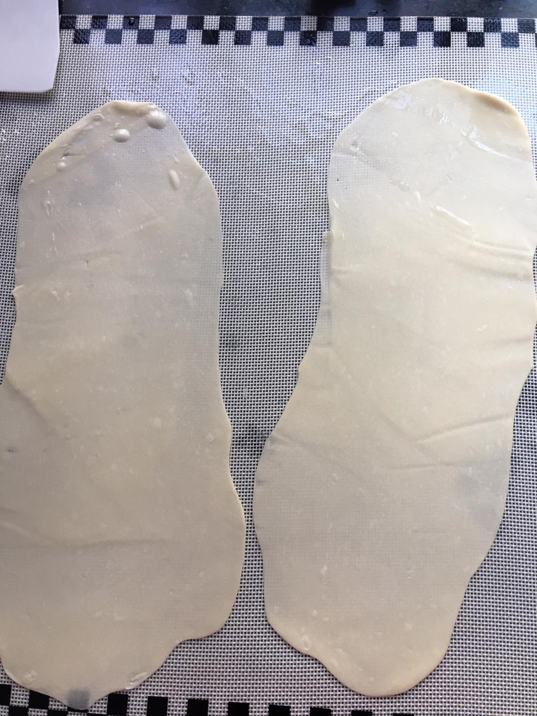 Roll two dough portions into thin ovals