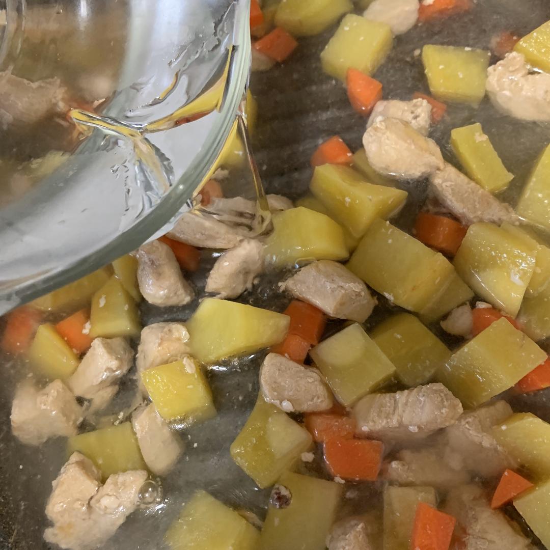 Adding water to cover the curry ingredients