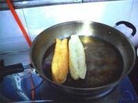 Stretching pressed youtiao dough before frying