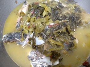 Lift the bones and greens into the serving bowl