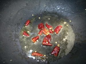 Pour the hot chili oil over the finished bowl