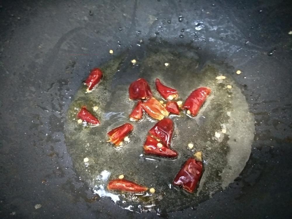 Pour the hot chili oil over the finished bowl