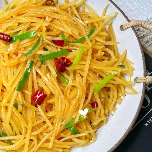 Oyster sauce hot and sour shredded potatoes (suan la tu dou si) - crisp potato matchsticks in a glossy, tangy, chili-flecked sauce