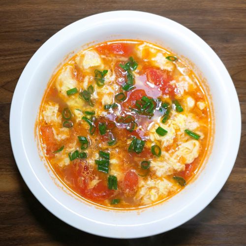 Tomato egg drop soup (xi hong shi ji dan tang) with silky egg ribbons in a bright tomato broth
