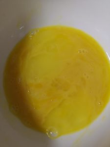 While the pot of water comes up to a boil, beat the eggs in a bowl with a spoonful of cooking wine. Beat until the mixture is uniform and just slightly foamy — the wine makes the egg ribbons more tender and fragrant.