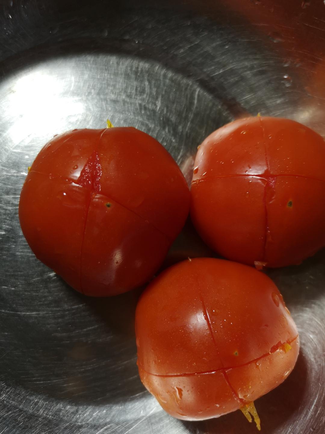 Drop the scored tomatoes into the boiling water for exactly 5 seconds. The skin will loosen at the cuts and pull away from the flesh almost on its own. Lift them out with a slotted spoon, let them cool for a moment, then peel — never skip this step; the skin dulls the tomato flavor and texture.