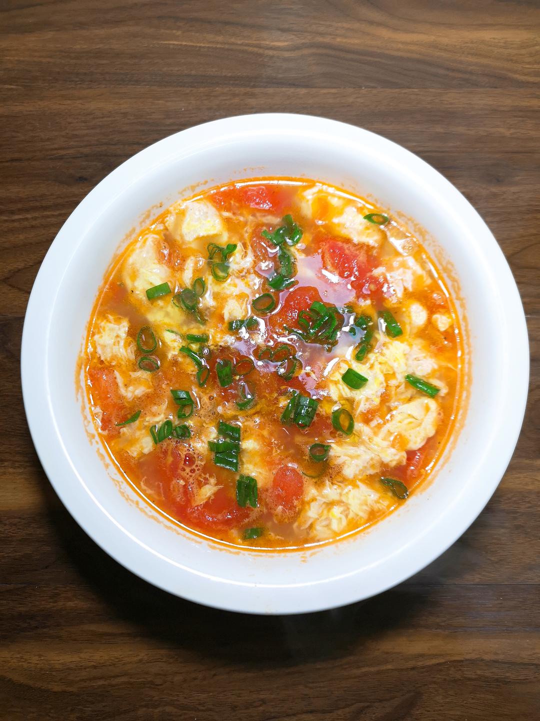 Tomato egg drop soup (xi hong shi ji dan tang) with silky egg ribbons in a bright tomato broth