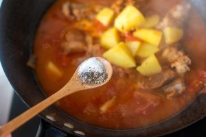 Season with salt and pepper and simmer until the potatoes are tender