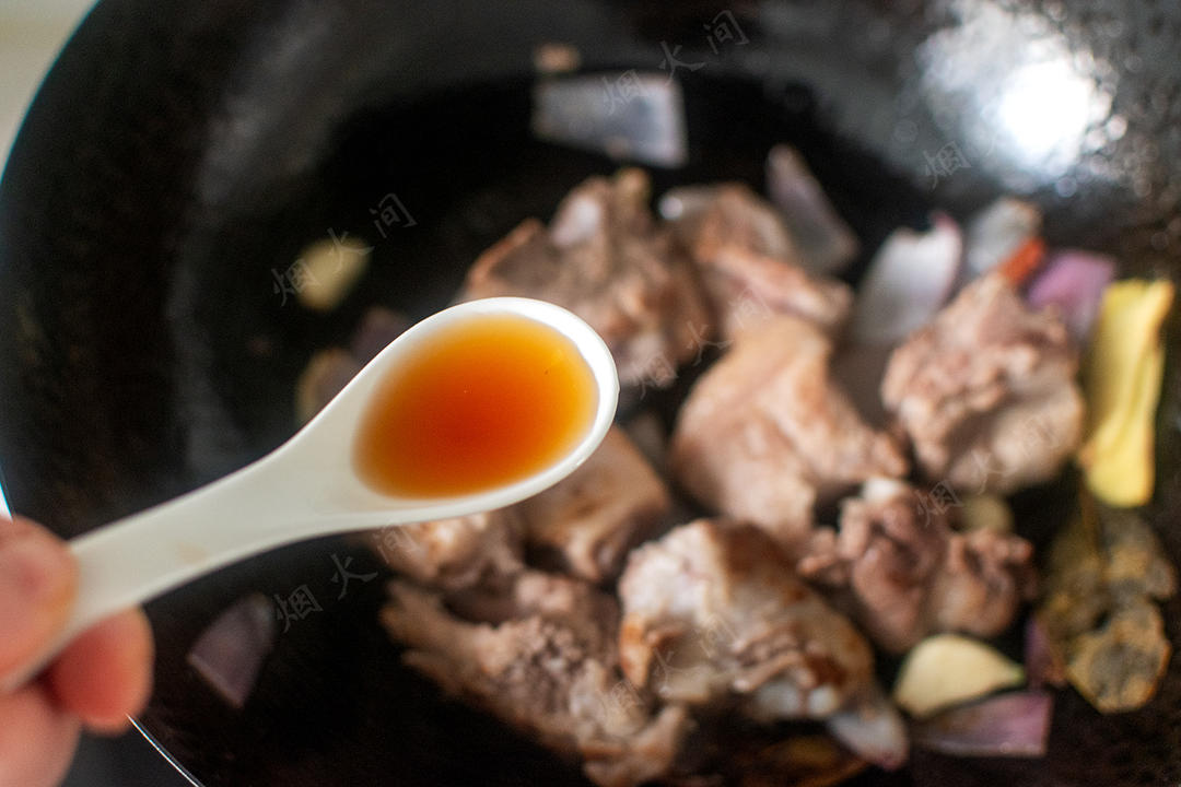 Add the yellow wine and light soy and deglaze the pot