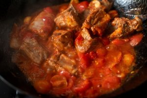 Cook until the tomato mixture releases its red oil