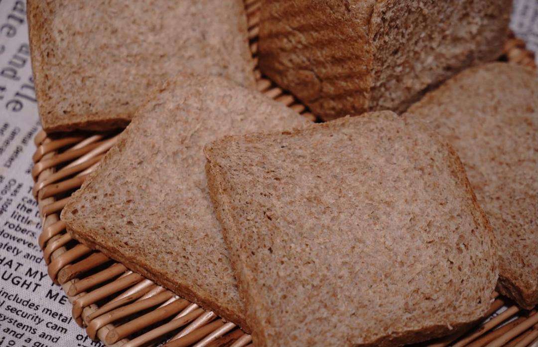 A baked sugar-free whole wheat toast loaf with a craggy golden crust