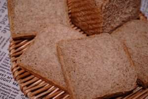 A close-up of the sliced loaf showing a slightly dense bottom from hurried steaming