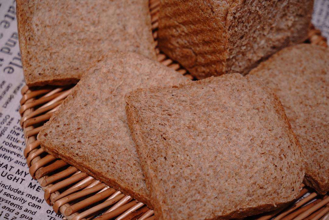 A close-up of the sliced loaf showing a slightly dense bottom from hurried steaming