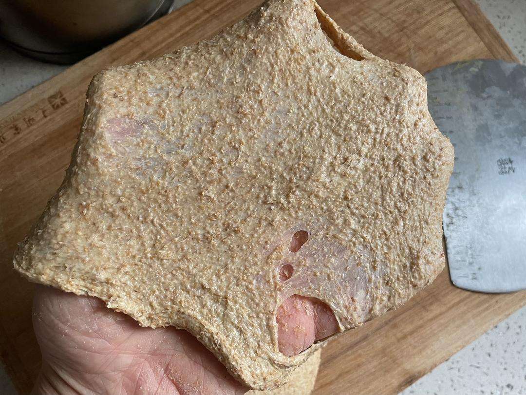 Stretch a small piece of dough into a thin membrane to test the gluten development