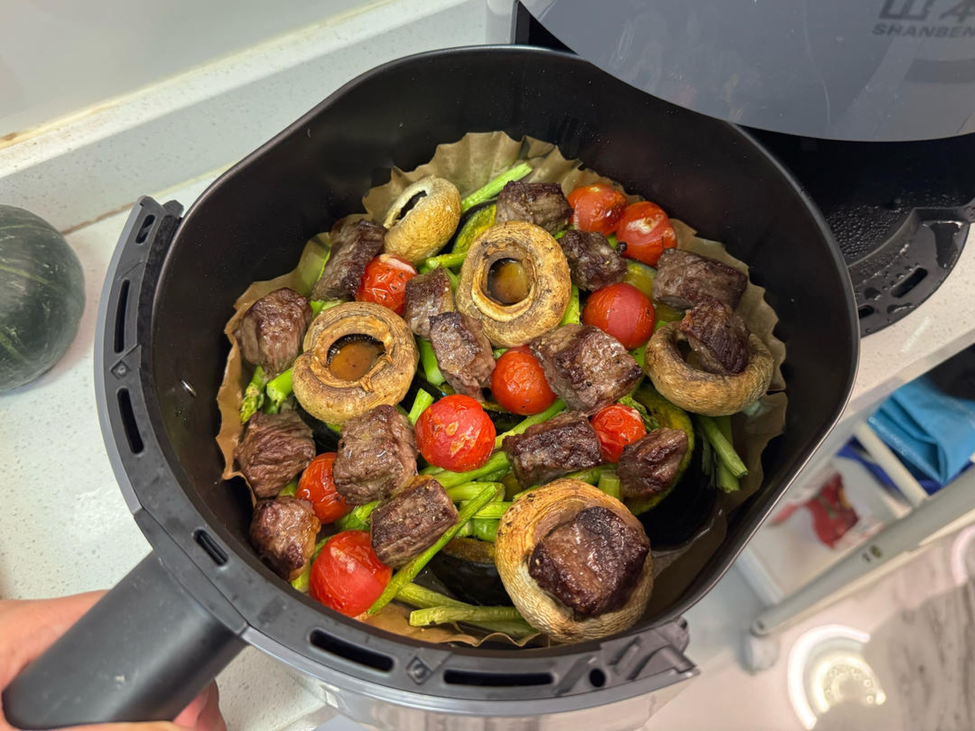 Finished air fryer beef and roasted vegetables on a serving platter