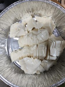 Turn the silken tofu out into a foil container and score the surface 3-4 times with a knife.