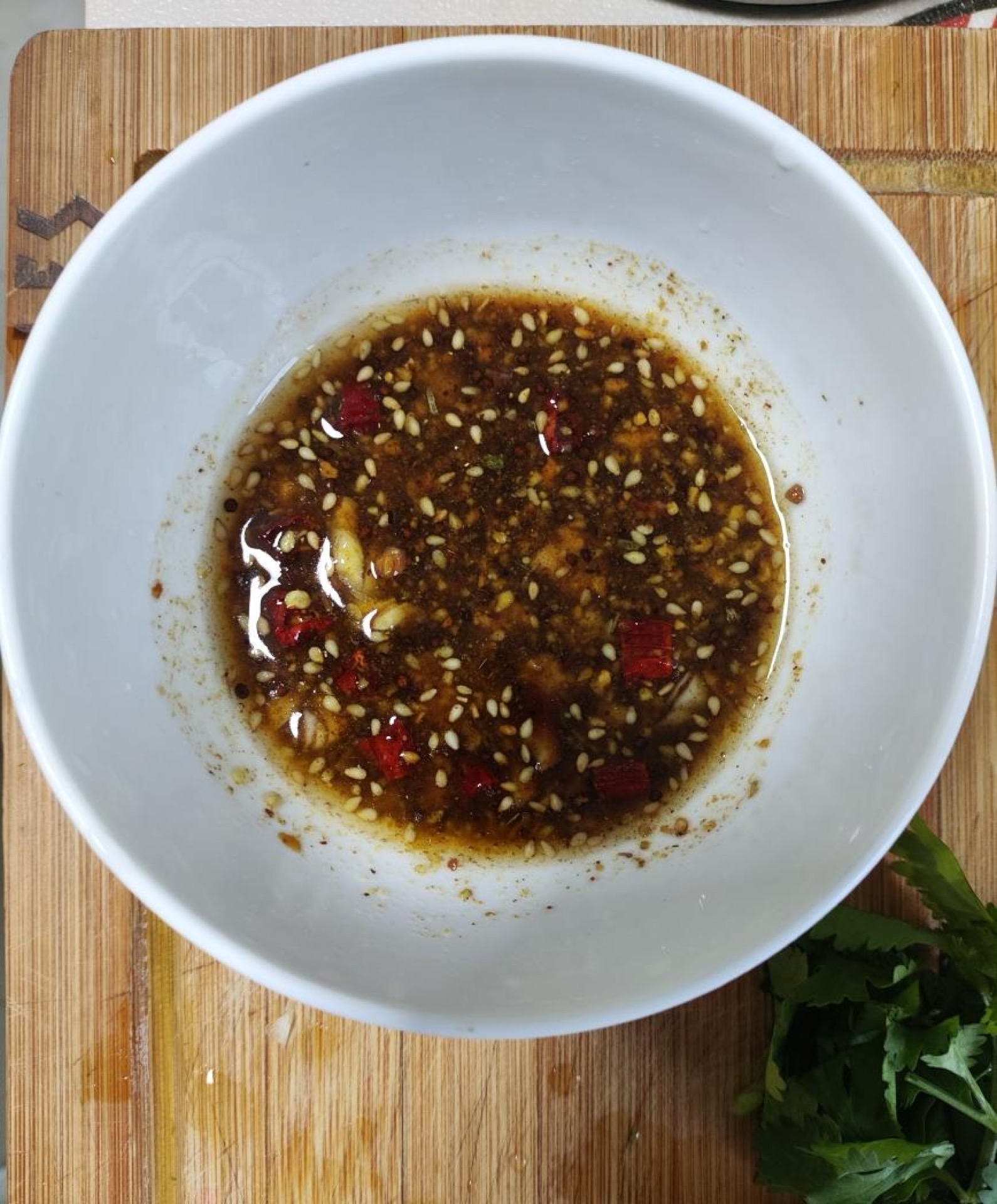 Heat a little oil in a pan until it just begins to smoke, pour it over the aromatics so it sizzles, then stir in 2 tablespoons of soy sauce and 1 tablespoon of oyster sauce and mix