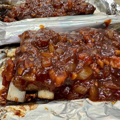 Glazed oven baked BBQ ribs on a platter